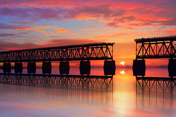 Beautiful colorful sunset or sunrise with broken bridge stock photo