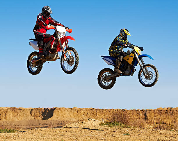 Jumping in unison Action shot of two dirt bikers mid-airhttp://195.154.178.81/DATA/i_collage/pi/shoots/781261.jpg bmx racing stock pictures, royalty-free photos & images