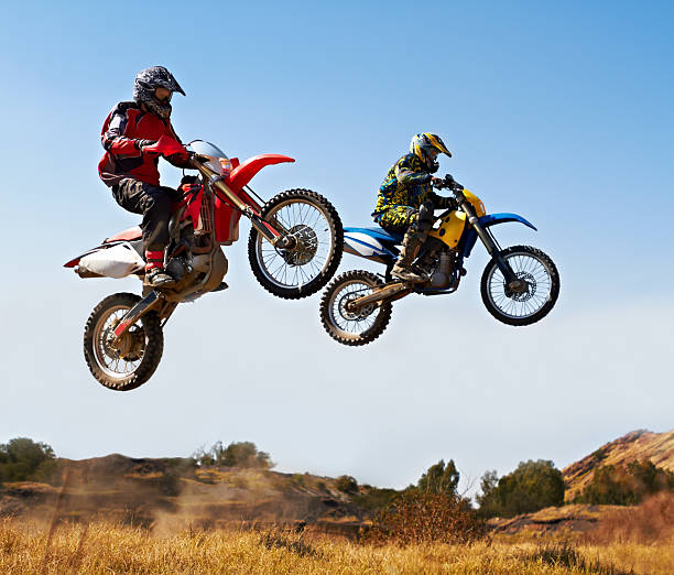 Nothing compare to the thrill of a good race Action shot of two dirt bikers jumping with their bikes over a fieldhttp://195.154.178.81/DATA/i_collage/pi/shoots/781261.jpg bmx racing stock pictures, royalty-free photos & images