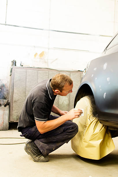 istock Mechanic repairing car 471621997
