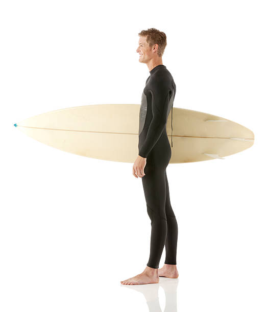 istock Smiling male surfer standing with a surfboard 471623403