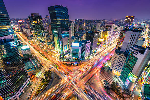 Time-lapse photo of traffic in Gangnam, South Korea Night traffic zips through an intersection in the Gangnam district of Seoul, South Korea. aerial view of seoul south korea capital city stock pictures, royalty-free photos & images