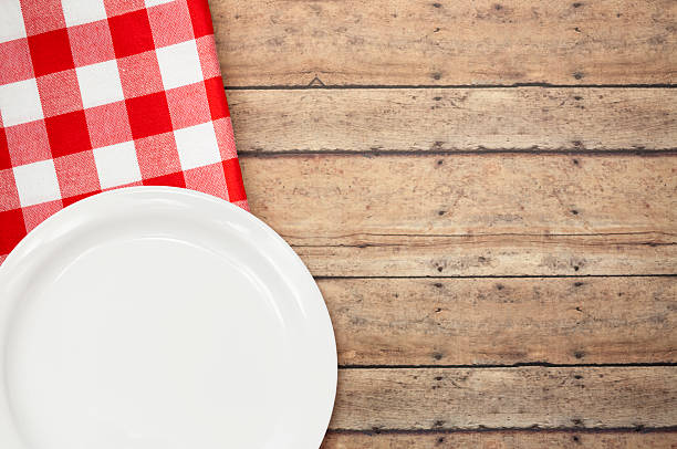 istock Red Checked Napkin with Dish on Wooden Picnic Table 471625892