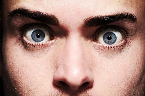 Fear in his eyes Closeup portrait of a young man with wide eyeshttp://195.154.178.81/DATA/i_collage/pi/shoots/781065.jpg staring stock pictures, royalty-free photos & images