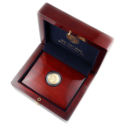 Gold coin in wooden box.