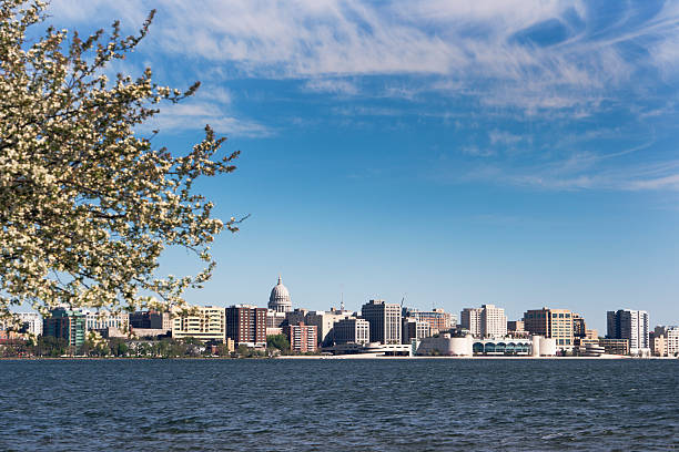 Madison, Wisconsin State Capitol Building and Downtown from Lake Monona Subject: Horizontal cityscape of Madison, Wisconsin, featuring the State Capitol Building and downtown as seen from Lake Monona in the springtime. wisconsin state capitol photos stock pictures, royalty-free photos & images