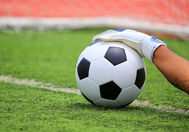 istock Soccer goalkeeper's hands reaching for the ball 471629129