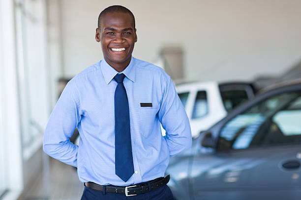 istock afro american salesman working at vehicle showroom 471629270