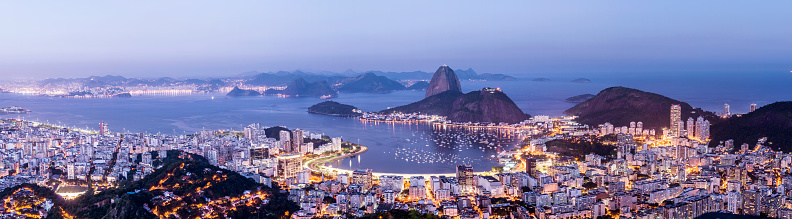 Panoramic twilight aerial view of Sugarloaf mountain, Guanabara Bay and the downtown city area of Botafogo of Rio de Janeiro, Brazil