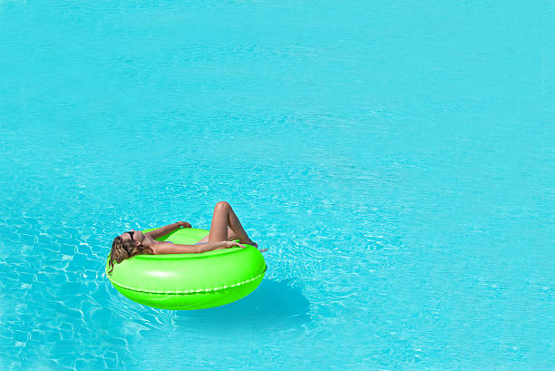 istock Girl relaxing in swimming pool 471632946