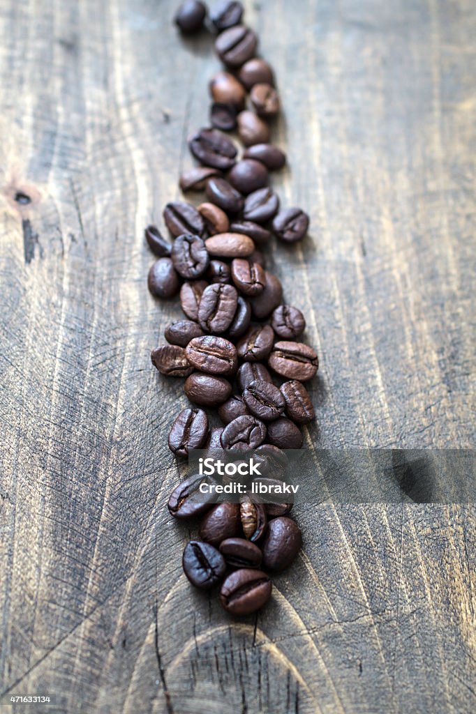 Coffee beans Coffee beans on old wooden table, close up 2015 Stock Photo