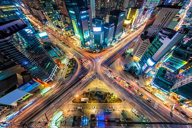 Night traffic zips through an intersection in the Gangnam district of Seoul, South Korea.