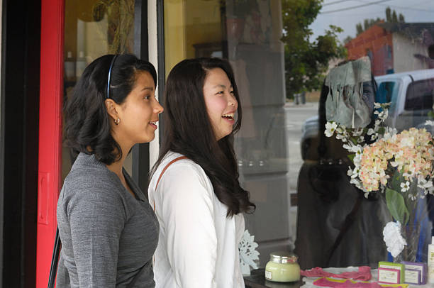 istock Two Attractive Young Women Standing in Front of Store Window 471633761
