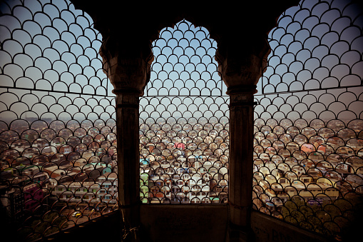 High angle view of New Delhi from tower. Indian arch window in the foreground.