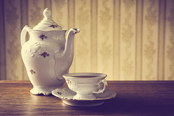 istock ld-fashioned vintage jug with tea with wallpaper background 471634478