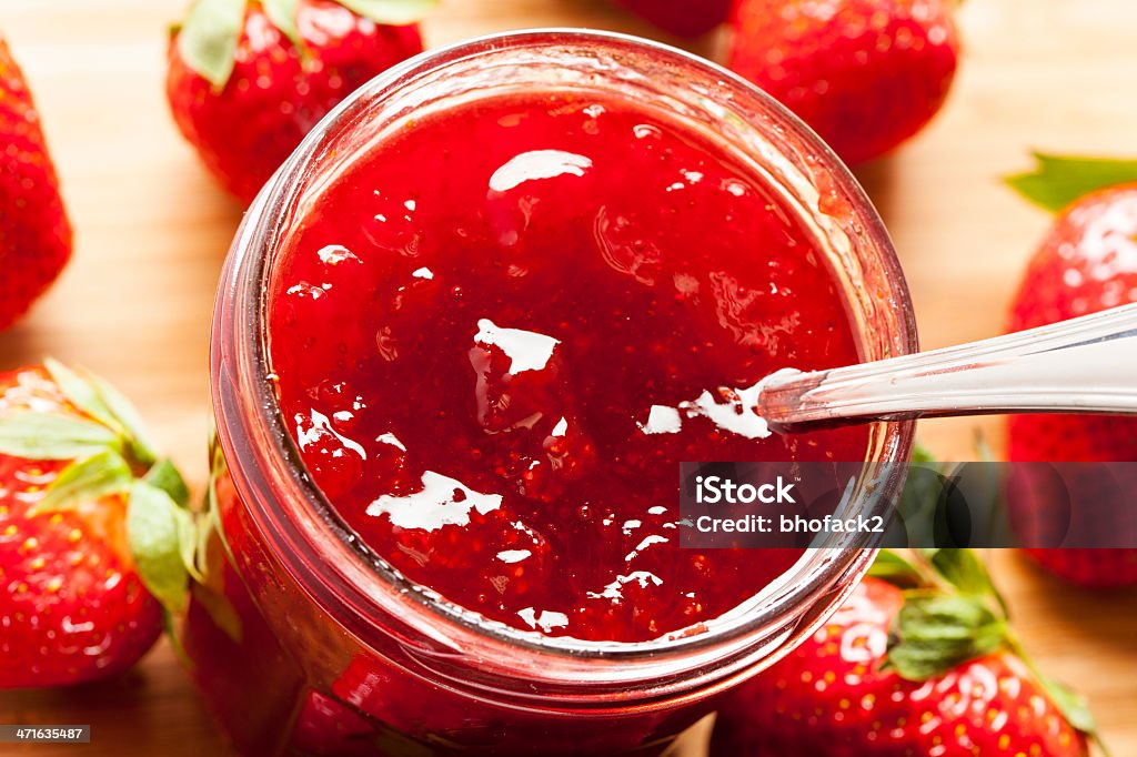 Homemade Organic Red Strawberry Jelly Homemade Organic Red Strawberry Jelly against a background Berry Stock Photo