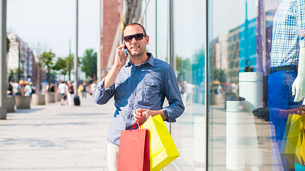 istock Man shopping with many colored bags in his hand. 471636501