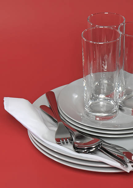istock Pile of white plates, glasses, forks, spoons. 471637427