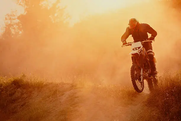 Motocross rider on track, strong grain added to create atmosphere.
