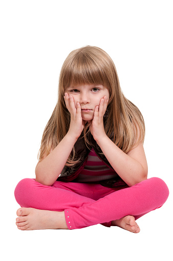 Beautiful little girl sitting with her legs crossed