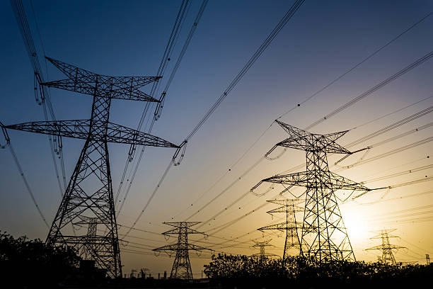 istock High Voltage Lines, electricity pylon with colorful sky and sun 471638054