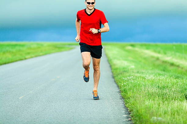 istock Man running on country road 471638881