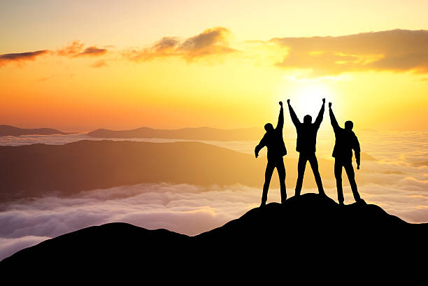 silhouette di team - climbing rock men mountain climbing foto e immagini stock