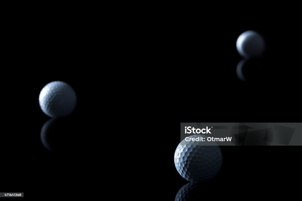 Golf balls isolated on black background. Several golf balls isolated on black background with blank copy space for text. Black Background Stock Photo