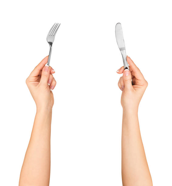 istock Knife and fork in hands isolated on white background 471641644