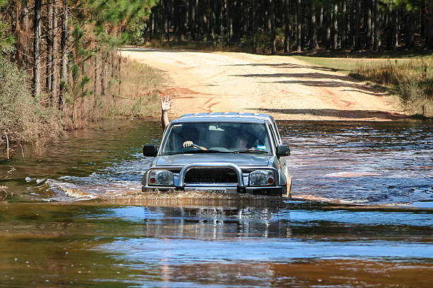 Four wheel drive crossing river stock photo