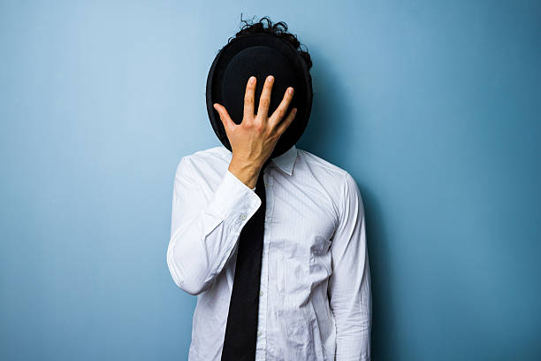 istock Businessman hiding his face behind a bowler hat 471643007