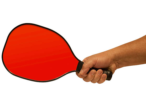 Pickleball Paddle in Hand 1 Simple illustration of hand gripping pickleball paddle.  Clipping path for hand and paddle included.  A clipping path for the paddle face is also included so that the color can be easily changed. table tennis racket stock pictures, royalty-free photos & images