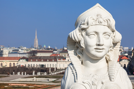 Wien, Austria - March 9, 2014: Rococo Sphinx in the Belvedere gardens. In the background - top view of Vienna