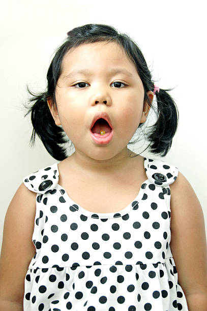 istock Little girl taking drugs 471647617