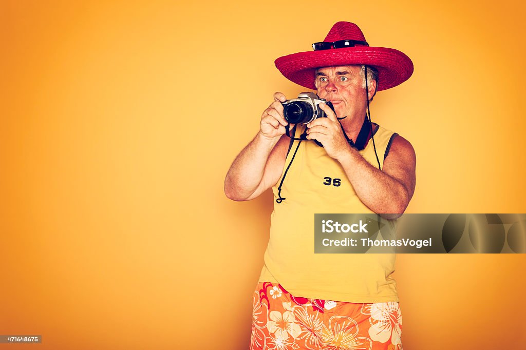 The Tourist - Cool Camera Sombrero Humor Hawaiian Tourist on yellow background. Sunburned Stock Photo