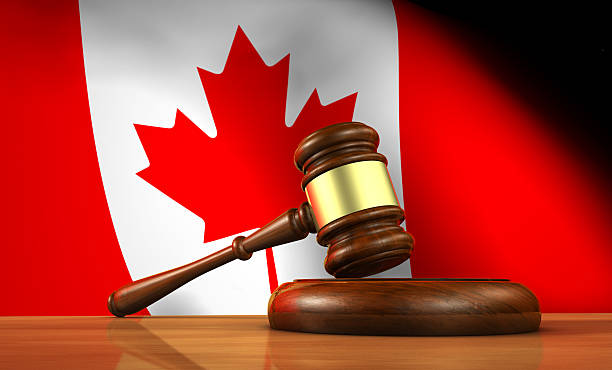 Canadian Law And Justice Concept Law and justice of Canada concept with a 3d rendering of a gavel on a wooden desktop and the Canadian flag on background. canadian culture stock pictures, royalty-free photos & images