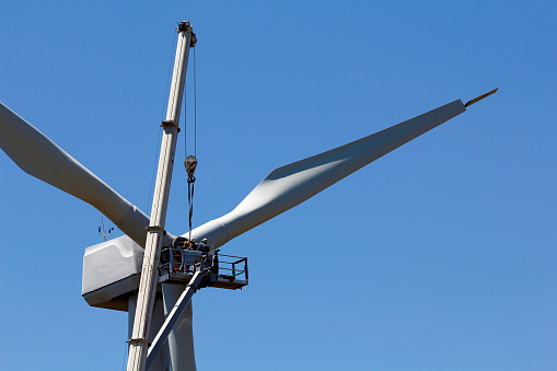 Wind turbine being repaired for some workers. For power generation