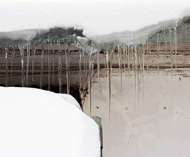 istock long icicles hanging from the roof 471651445