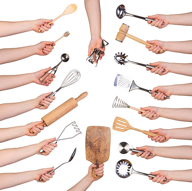 Woman holding kitchen utensils Woman holding kitchen utensils isolated on white background wooden spoon stock pictures, royalty-free photos & images