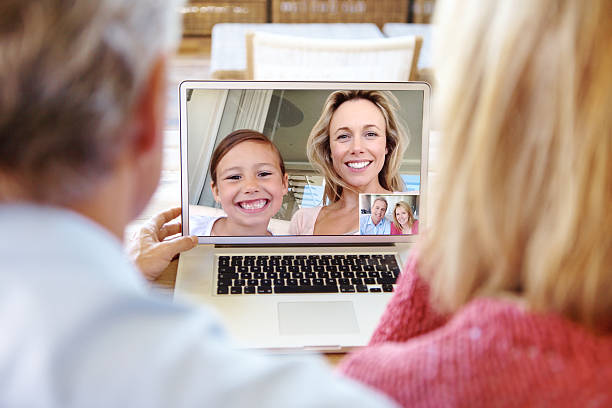 ligar apesar de a distância - wireless technology cheerful granddaughter grandmother imagens e fotografias de stock