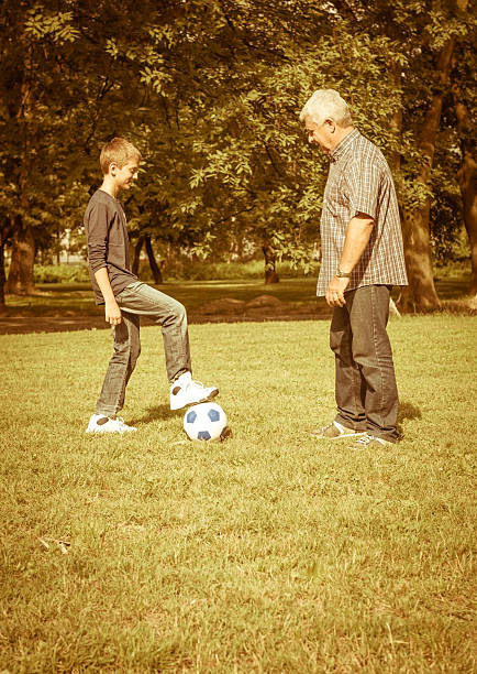 istock Grandfather and grandson playing in the park 471652437