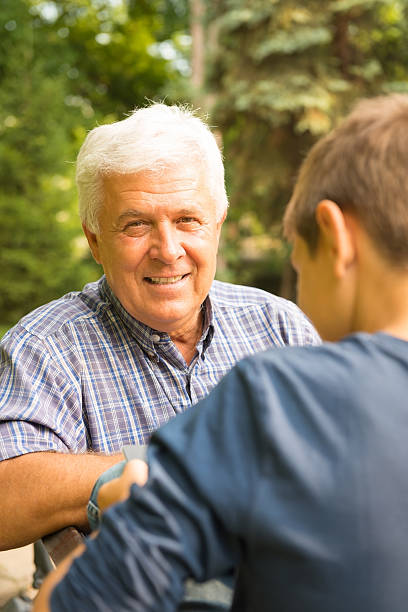 istock Grandfather and grandson in the park 471652633