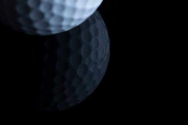 istock Golf ball with reflection isolated on black background. 471653462