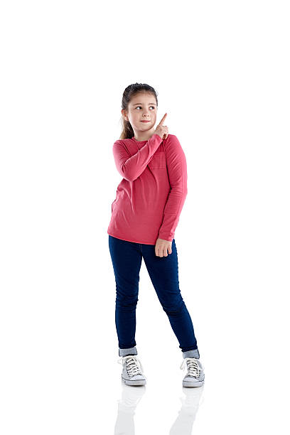 Little girl pointing at copyspace on white