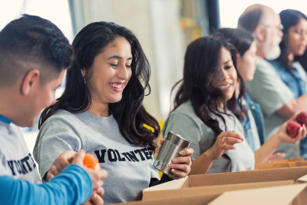 istock Diverse volunteers are sorting donated into boxes at food bank 471659502