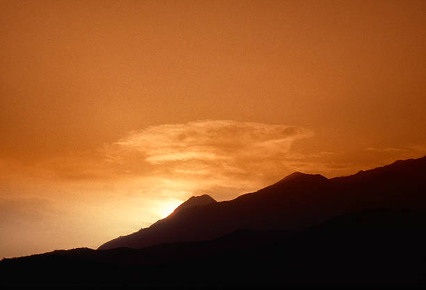 istock Sunset with silhouette of mountain 471660355