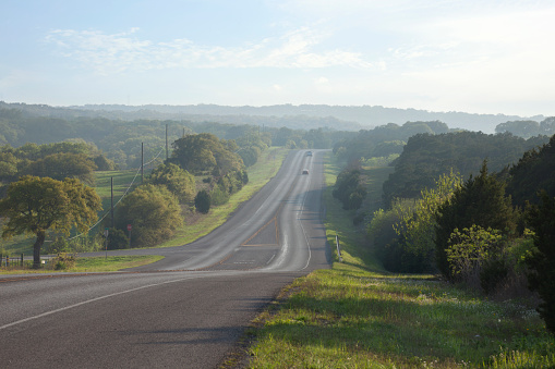 A road in the Texas Hill Country near sundown during spring