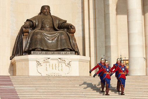 Ulan Bator, Mongolia - January 25, 2015: four soldiers belonging to Mongolian Armed Forces Honorary Guard descend the stairs at the Monument of Chinggis Khaan, in Sukhbaatar Square.