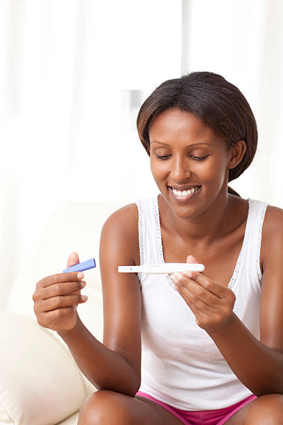 istock Woman looking at pregnancy test positive. 471662085