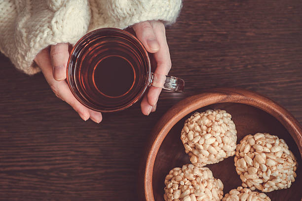 istock Woman holding cup of black tea 471663584